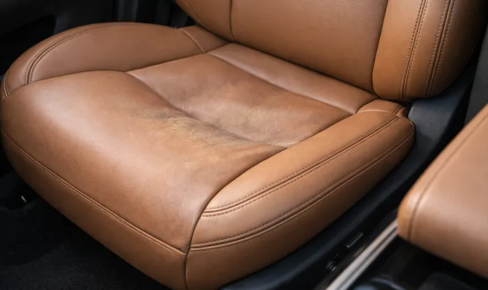Before Seat Foam Restoration and Leather Repainting on Tan Leather Seat With Collapsed Foam in Los Angeles