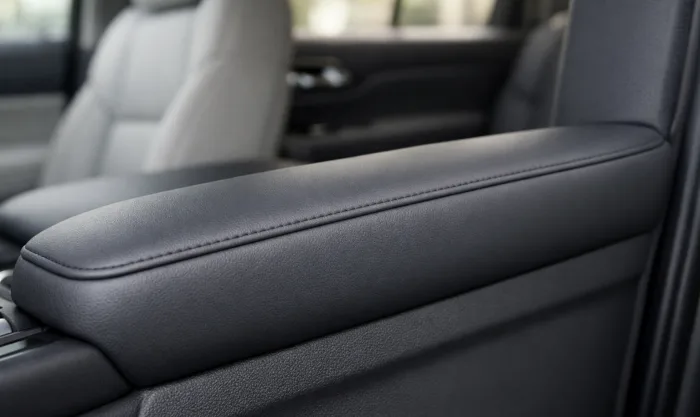 After Armrest Foam Restoration and Vinyl Reupholstery on Dark Gray Vinyl Door Armrest in Los Angeles