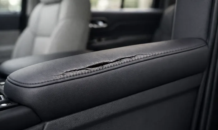 Before Armrest Foam Restoration and Vinyl Reupholstery on Dark Gray Vinyl Door Armrest in Los Angeles