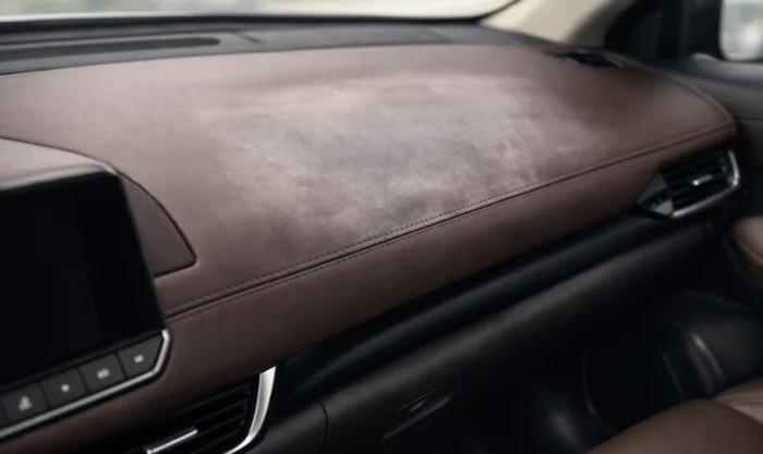 Before Leather Dashboard Repainting After UV Fading on Dark Brown Leather Dashboard in Los Angeles