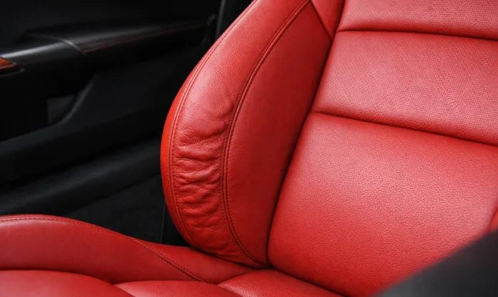 Before Side Bolster Foam Deformation Repair on Red Genuine Leather Seat Side Support in Los Angeles