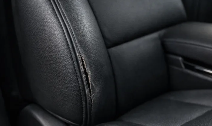 Before Driver Seat Bolster Seam and Surface Repair on Black Leather Side Bolster in Los Angeles