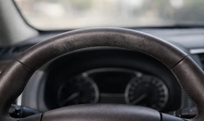 Before Steering Wheel Scuff and Grease Stain Restoration on Dark Brown Leather Steering Wheel in Los Angeles
