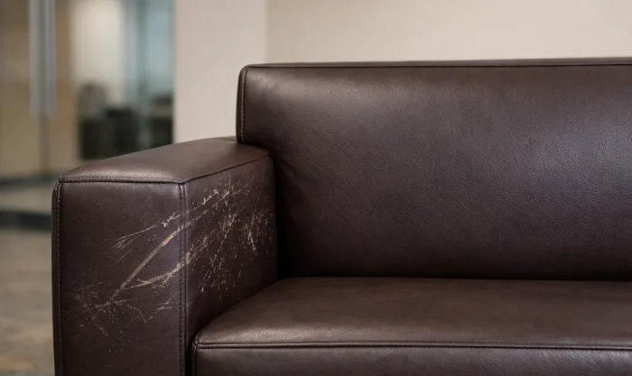Before Lobby Sofa Scratch and Scuff Repair After Office Relocation for Dark Brown Pigmented Leather Lobby Sofa in Los Angeles